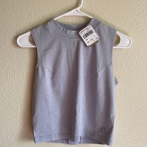 Two NTW Reebok crop tops